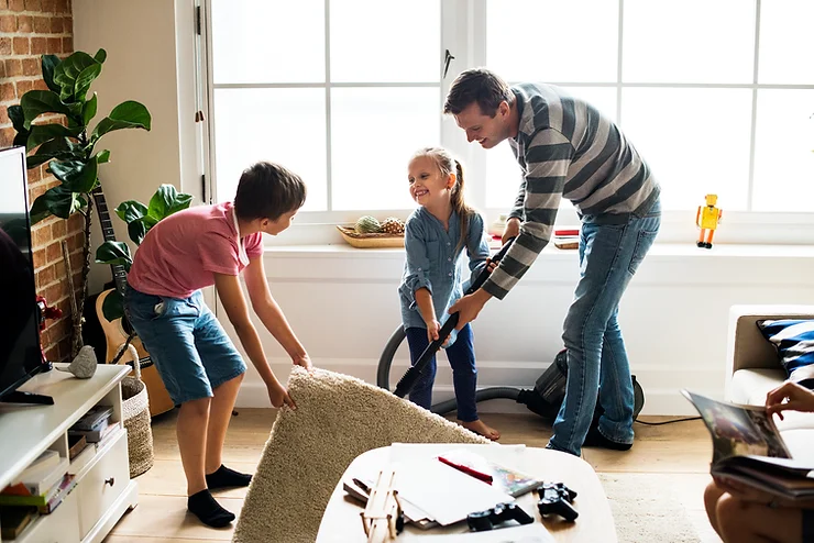 Dad works with his two children to do quick cleaning tasks.