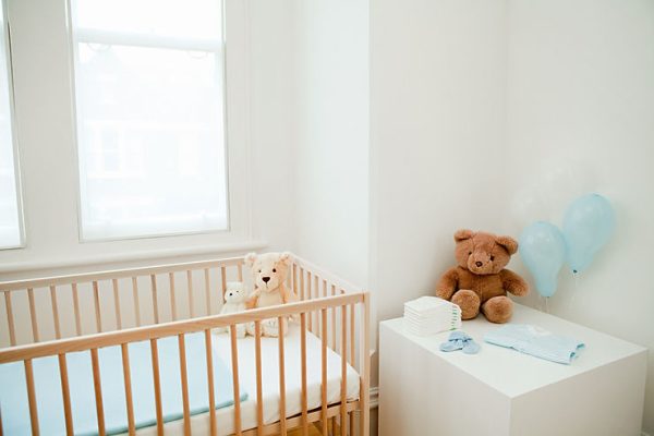 Transitioning a toddler from a crib to a kid-size bed with a crib and teddy bears in the photo.