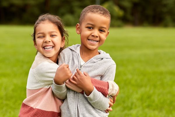 Young children playing in each others' personal space