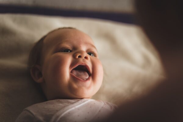 When do babies start laughing?