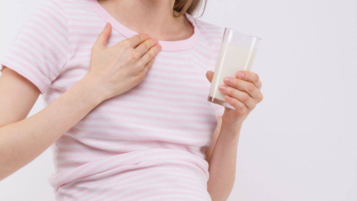 pregnant woman with heartburn/sickness and drink of milk